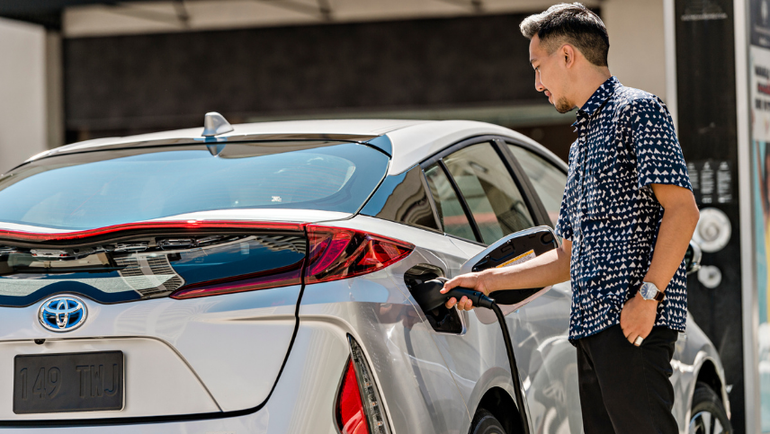 Man fueling a 2022 Prius Prime Limited in Classic Silver Metallic.